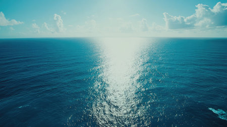 Experience the beauty of the ocean with its serene waters reflecting sunlight, creating a peaceful atmosphere perfect for relaxation and exploration under a bright sky.の素材