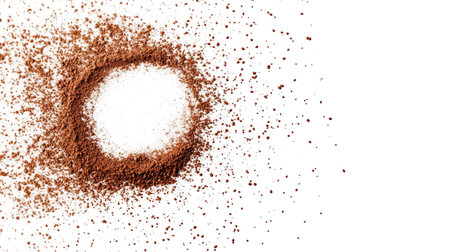 An artistic display of brown powder forming a circle around a central white pile on a clean surface, perfect for showcasing culinary themes or creative food photography.の素材