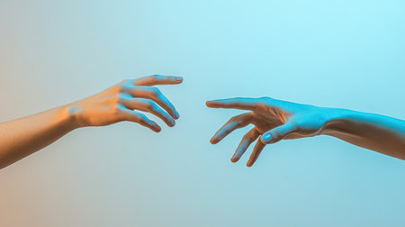 Two elegantly posed human hands extend towards each other, set against a soft color gradient background, symbolizing connection, unity, and the beauty of human interaction.の素材