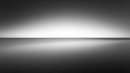 Explore a stunning minimalist black and white landscape featuring a soft gradient and calm reflection on the water, evoking feelings of serenity and tranquility.の素材