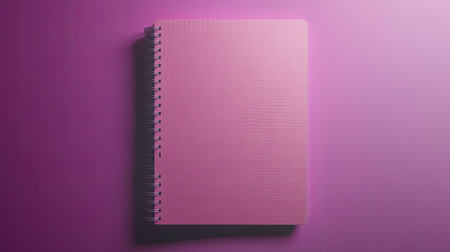 A vibrant pink notebook lies flat against a smooth purple background, showcasing a subtle texture. This image evokes creativity and minimalism, perfect for educational or design projects.の素材