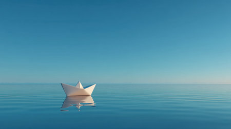 A serene paper boat floats gently on the calm water, reflecting the clear blue sky. This tranquil scene evokes feelings of peace, solitude, and artistic minimalism.の素材