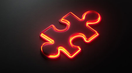 A striking neon red puzzle piece illuminated against a dark background. Perfect for themes of connection, teamwork, and creative solutions in modern design projects.の素材