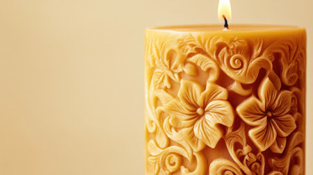 A beautifully carved candle featuring intricate floral patterns, casting a warm glow. Perfect for creating a serene ambiance in any space.の素材