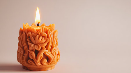 A beautifully carved decorative candle featuring intricate floral patterns emits a warm glow, enhancing the atmosphere of tranquility and relaxation in any setting.の素材