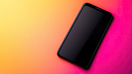 A black smartphone lies on a vibrant gradient background, showcasing its sleek design and modern aesthetic ideal for technology-themed visuals or promotional uses.の素材