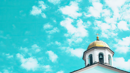 A stunning view of a church dome with a golden top set against a bright blue sky filled with fluffy clouds, capturing a serene and tranquil atmosphere.の素材