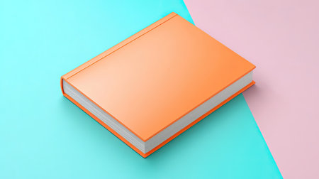 A bright orange book placed on a colorful pastel background, featuring soft blue and pink tones. Ideal for themes of education, creativity, and design.の素材
