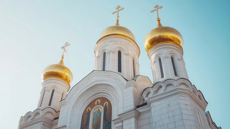Stunning photo of a church with golden domes against a clear blue sky, capturing the essence of spirituality and architectural beauty in a serene setting.の素材