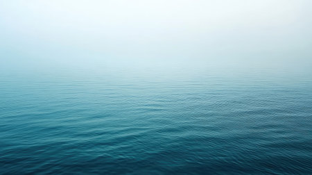 A serene and tranquil seascape featuring gentle waves and a soft horizon in soothing blue tones. Ideal background for relaxation or meditation themes.の素材