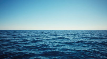 A serene view of a vast ocean stretching to the horizon under a clear blue sky, embodying peace and tranquility, ideal for inspiration and relaxation themes.の素材