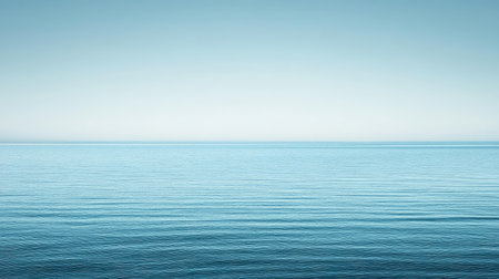A serene view of a calm ocean under a clear blue sky, emphasizing tranquility and beauty. This minimalist landscape invites relaxation and reflection.の素材