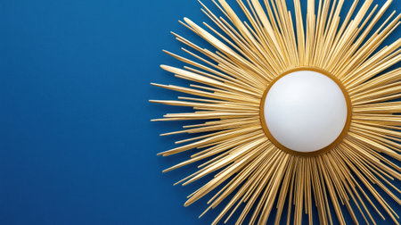 This stunning gold sunburst mirror features an intricate design, perfect for brightening up a modern space. The vibrant blue wall adds a rich contrast that elevates any interior decor.の素材