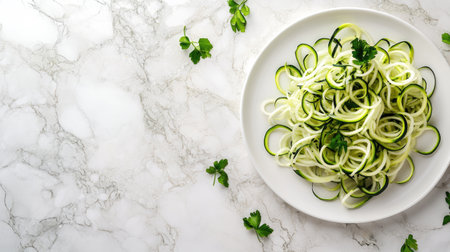 Fresh spiralized zucchini noodles adorned with green herbs showcase a healthy and vibrant meal option. Perfect for light and nutritious dishes.の素材
