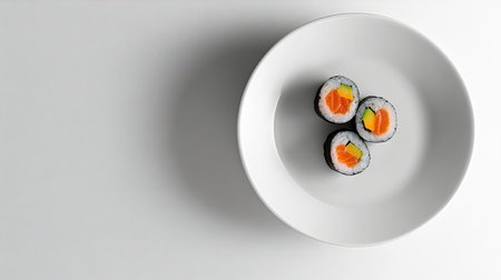 A minimalistic composition featuring three colorful sushi rolls on a white plate, highlighting fresh ingredients and presenting a modern dining experience.の素材