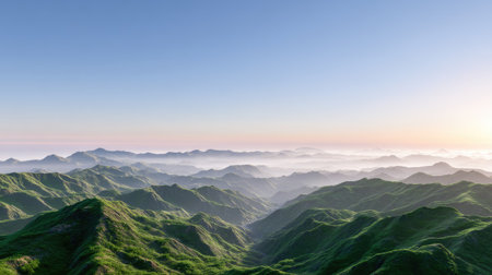 A breathtaking view of mountains covered in lush greenery under a clear sky at sunrise. Mist blankets the valleys, creating a tranquil and serene atmosphere.の素材