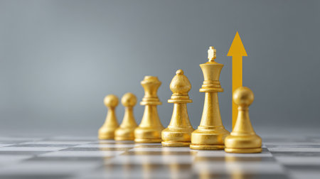 Conceptual image of a chessboard with money coins as pawns and a chart arrow moving upwards behind them, copy space on sidesの素材