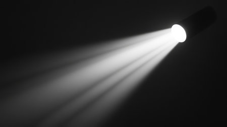 Single spotlight with an intense beam of light shining through a dark void, creating a sense of focus and drama in the center. No text, no people.の素材