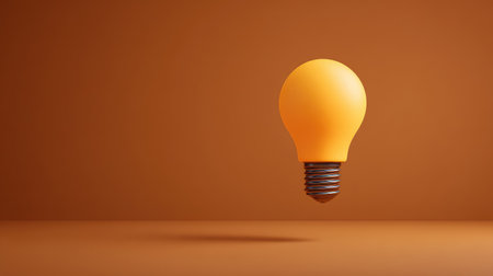 A glowing light bulb floating above a blank workspace, symbolizing inspiration and creative ideas, with soft shadows and wide copy space aroundの素材