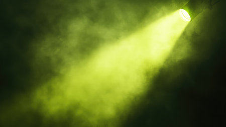A vibrant green spotlight cutting through a foggy space, with the green glow creating a calming yet dynamic atmosphere. No text, no people.の素材