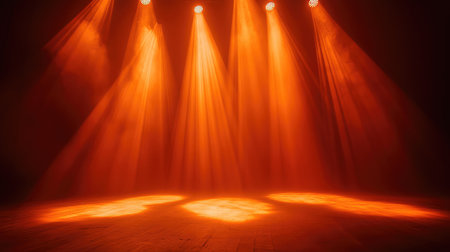 Orange spotlight illuminating empty space, with the surrounding darkness enhancing the glow of the beam and creating a mystical effect. No text, no people.の素材