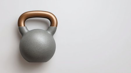 A modern grey kettlebell featuring a stylish brown handle, ideal for fitness enthusiasts looking to enhance their strength training and workout routines at home or in the gym.の素材