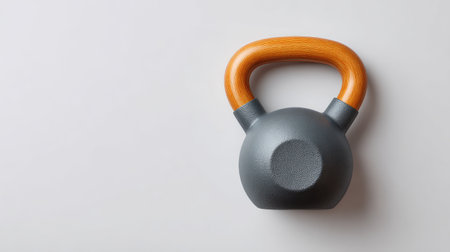 A modern kettlebell featuring an elegant wooden handle, perfect for strength training and fitness activities, set against a light gray background to enhance visual appeal.の素材