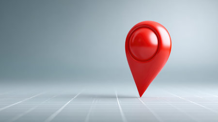 A vibrant red location pin stands out against a soft gray backdrop, perfect for illustrating concepts related to navigation, maps, and location-based services in a modern design context.の素材