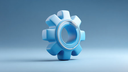 This image features a stylized blue gear on a soft gradient background, perfect for representing themes of engineering, technology, and industrial design in creative projects.の素材