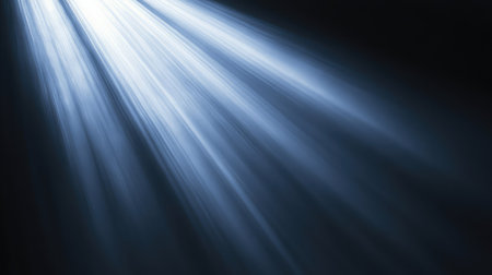 Spotlight casting a soft circle of light, with sharp contrast between the illuminated area and the surrounding darkness. No text, no people.の素材