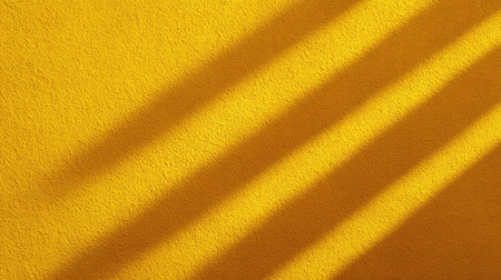 Bright yellow background featuring intriguing shadows that create a textured visual appeal, perfect for artistic projects and creative designs seeking a vibrant atmosphere.の素材