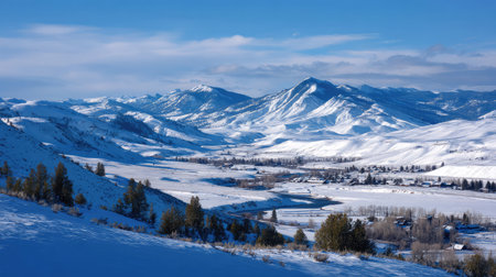 A breathtaking winter landscape showcasing majestic snow-capped mountains and a serene valley, highlighting the beauty and tranquility of nature's winter season.の素材