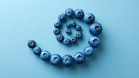 Artistic blueberry arrangement in spiral shape on pastel background, leaving center spaceの素材
