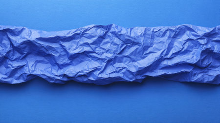 Blue paper background with crumpled texture and shadows, flat lay with empty space for productの素材