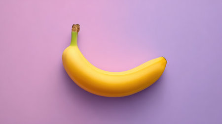 Single whole banana centered on a pastel background viewed from above, leaving space around for designの素材