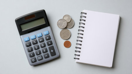 Financial service layout with calculator, coins, ledger notebook, and clean background for designの素材