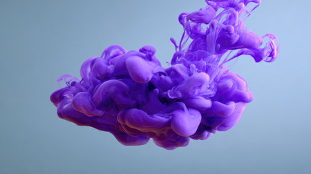 Purple ink swirling in water forming dreamy abstract shapes on clean background, open centerの素材
