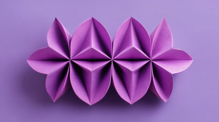 Top-down view of folded purple paper forming D background shapes, copy space in centerの素材
