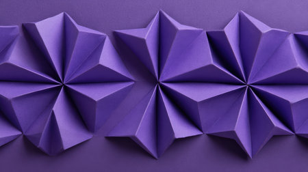 Top-down view of folded purple paper forming D background shapes, copy space in centerの素材