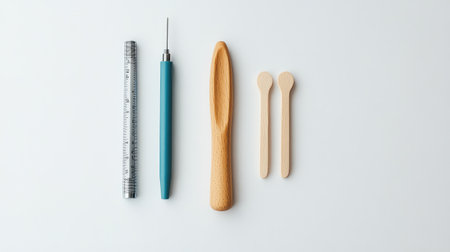 Clean flat lay of diagnostic reflex hammer, tongue depressors, and penlight on white background with space.の素材