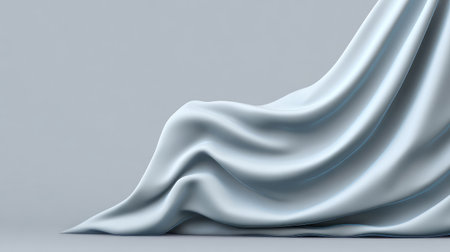 A delicate soft blue fabric drapes elegantly on a smooth surface, showcasing gentle folds and shadows, perfect for creating serene backgrounds and inspiring visual designs.の素材