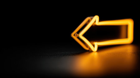 A striking neon left arrow sign shines against a dark surface, offering a soft glow effect. Ideal for design projects needing a creative directional element.の素材