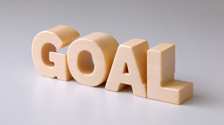 This image features wooden letters spelling the word "GOAL." The clean background emphasizes motivation and aspiration, ideal for personal growth themes.の素材