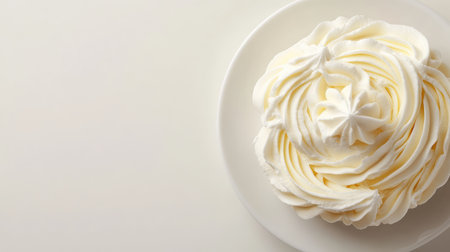 A soft, creamy swirl of whipped cream on a dessert plate, forming a smile shape, with open space for promotional content or copyの素材