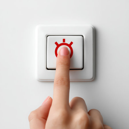 A hand gently presses a sleek, modern light switch in a well-lit environment, emphasizing minimalist design and the functional elements of contemporary living spaces.の素材