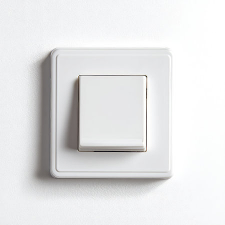 A simple, elegant light switch mounted on a white wall, showcasing a modern aesthetic suitable for contemporary decor and functional home environments.の素材