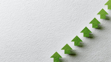 This image illustrates a concept of growth and success using green paper arrows moving upwards on a textured background, ideal for business, financial themes, and motivational projects.の素材
