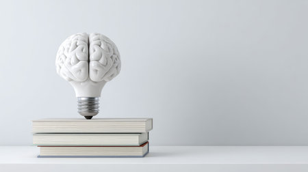 A unique visual representation of a brain-shaped light bulb on books, illustrating the connection between knowledge, creativity, and mental illumination. Ideal for educational themes.の素材
