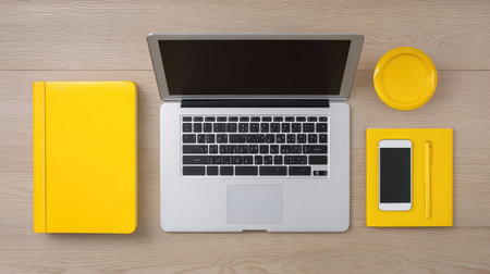 Bright and modern workspace setup featuring a laptop and yellow items, ideal for anyone looking to enhance productivity and creativity in a professional or personal environment.の素材