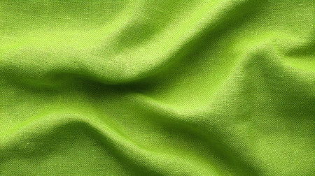 Captivating closeup of vibrant green fabric showcasing intricate woven patterns, perfect for creative projects, home decor inspirations, and fashion design endeavors.の素材